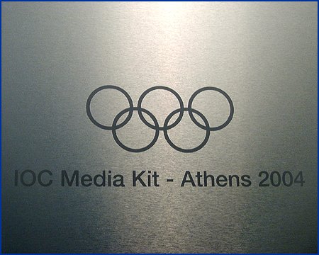 closeup olympic symbol on box folder, in metal and paper over board